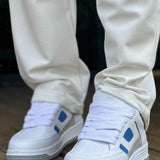 Men's white sneakers with blue strap accents and flat rubber sole