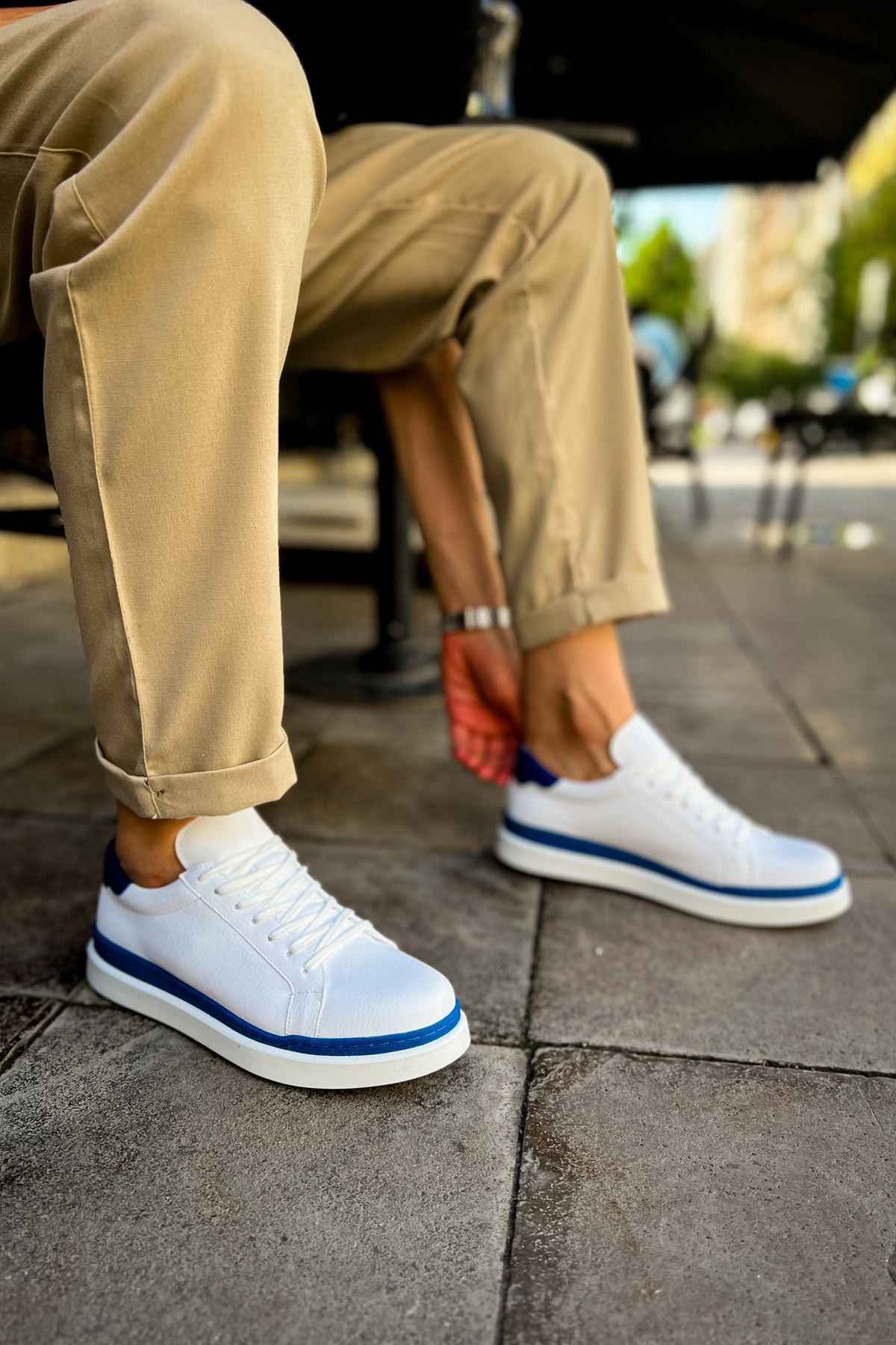 Men's white sneakers with blue collar and lace-up front