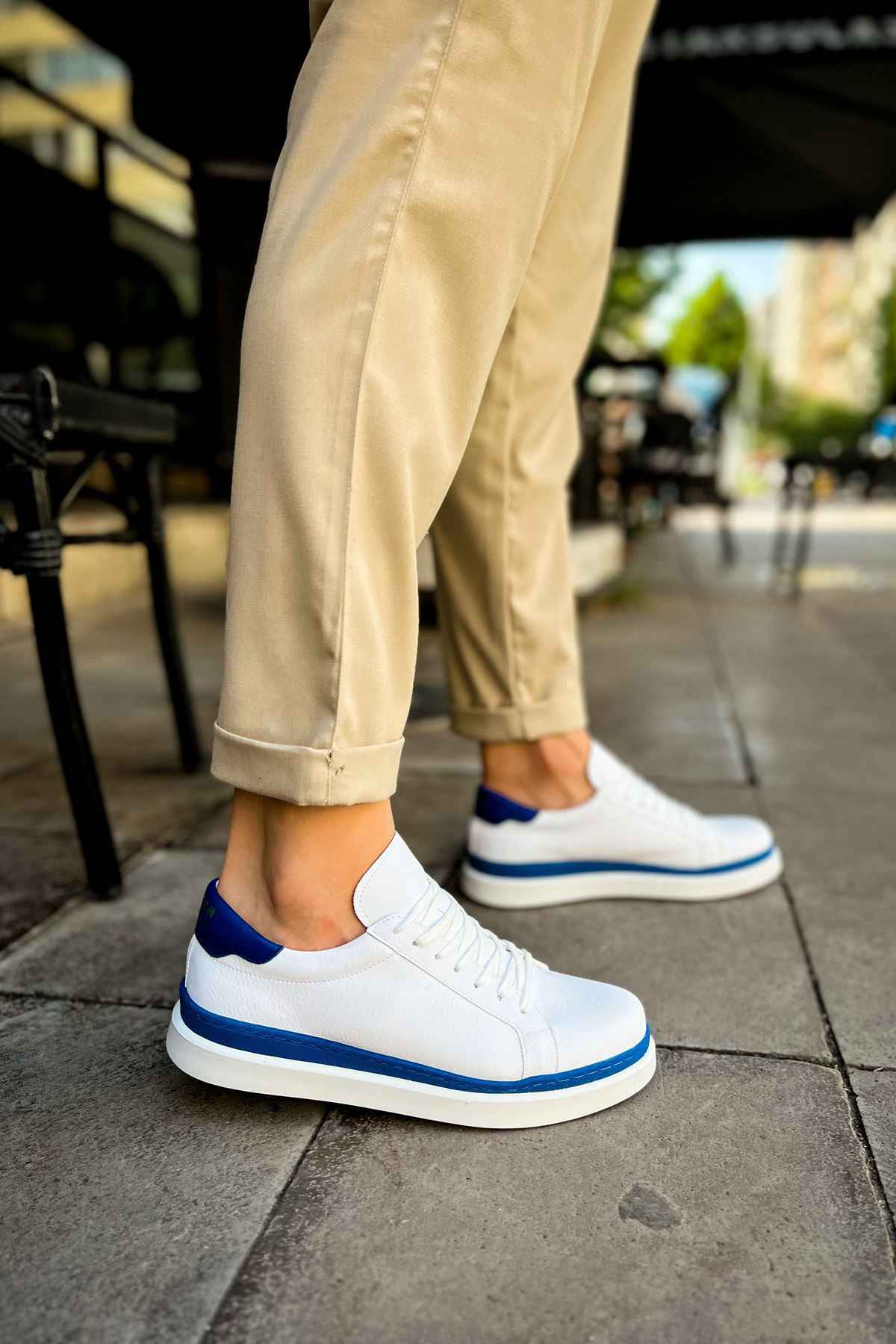 Men's white low-top sneakers with blue side stripes and white laces
