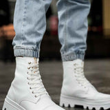 White lace-up high boots with padded collar and lug sole, front view