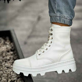 White lace-up ankle boots with eyelet hardware and rugged tread sole
