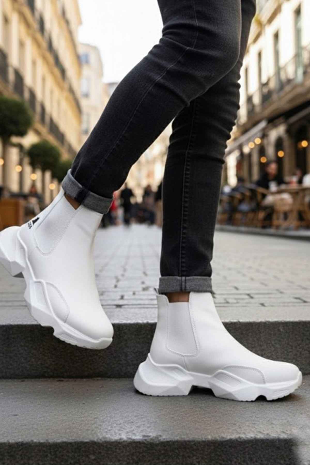 White ankle boots with chunky sole and elastic side panels; dark jeans cuffs above