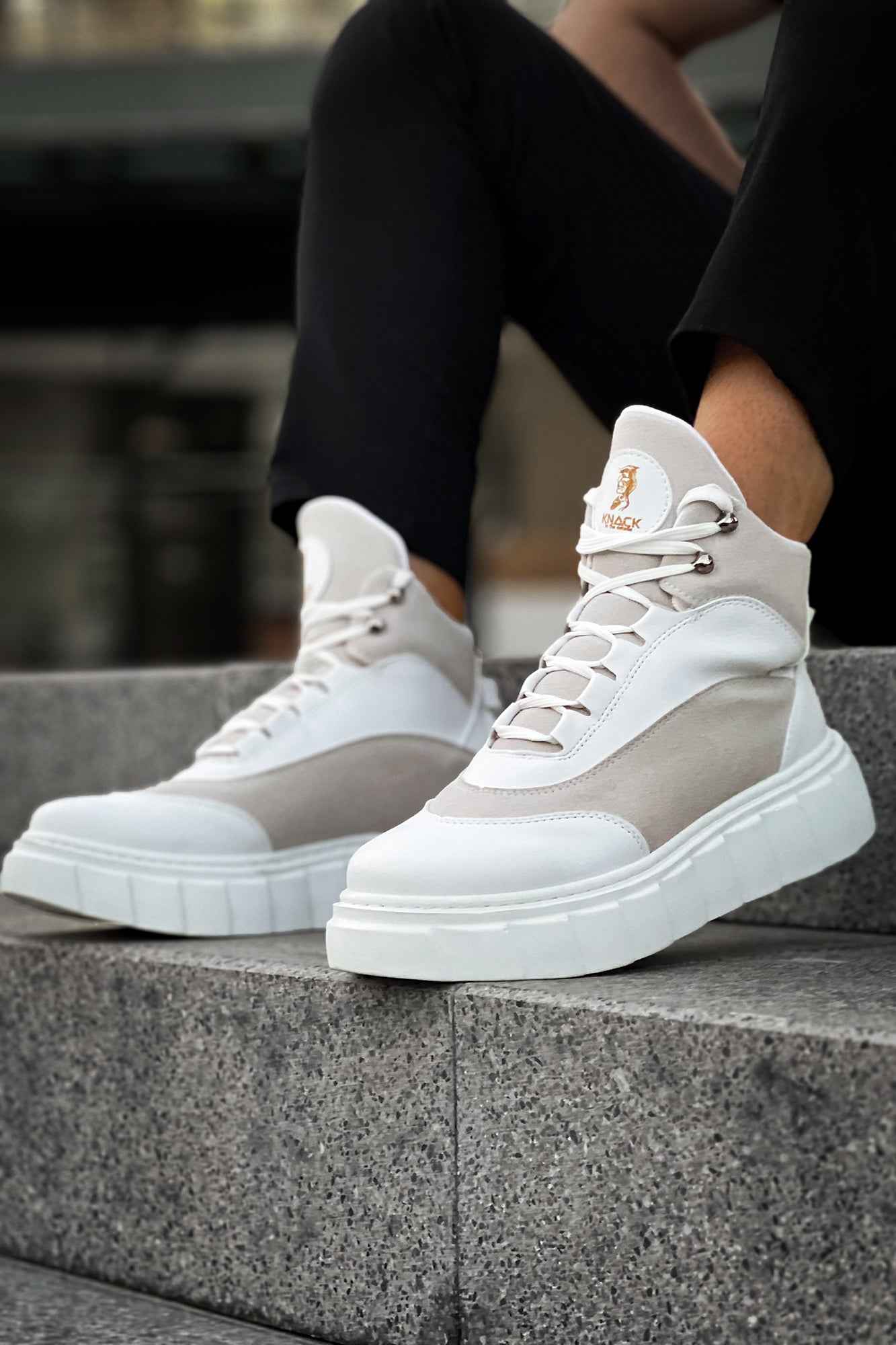 Men's white boots with gray panels, lace-up style, and cushioned platform sole