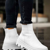 Men's white ankle boots with side elastic and lug sole, angled standing