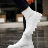 Men's white ankle boots with side elastic and lug sole, lifted foot