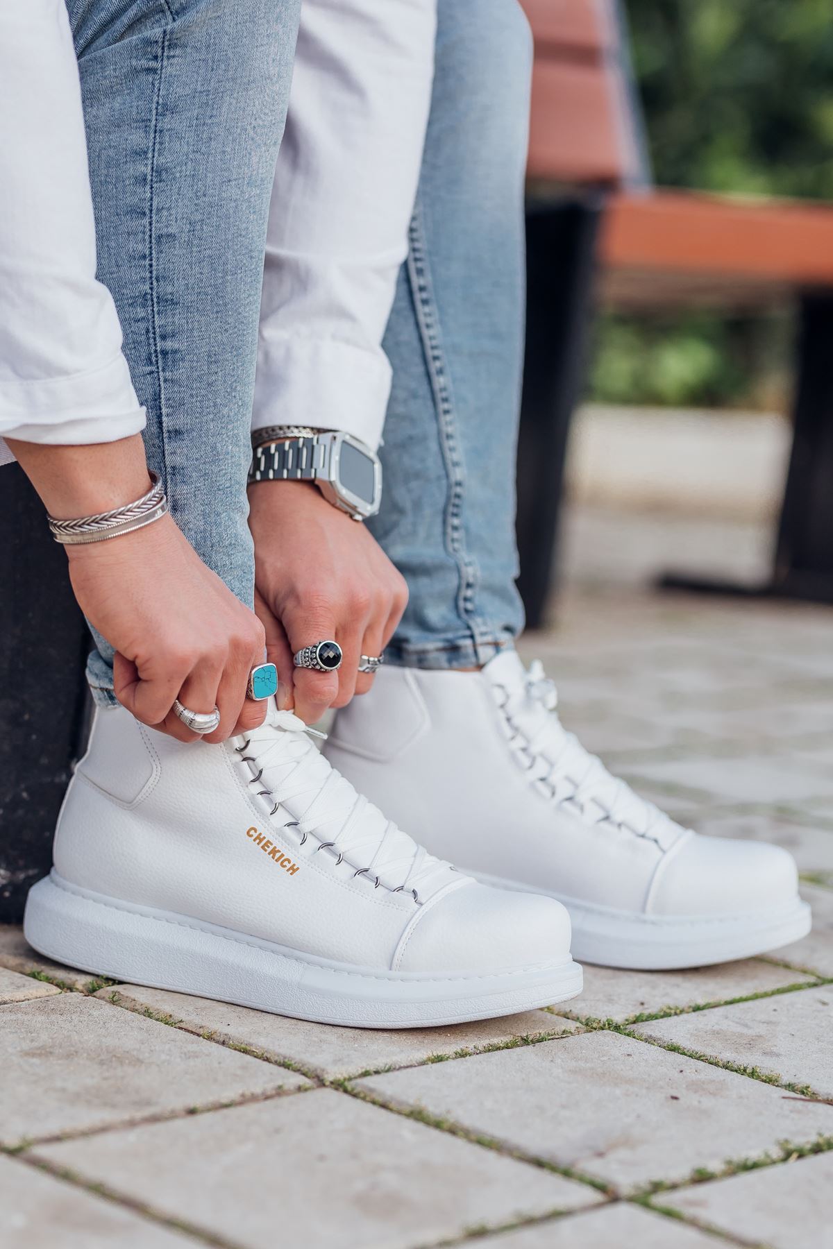 White lace-up boots with stitched panels and a rubber sole