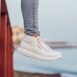 White low-top lace-up boots with side text logo and flat sole