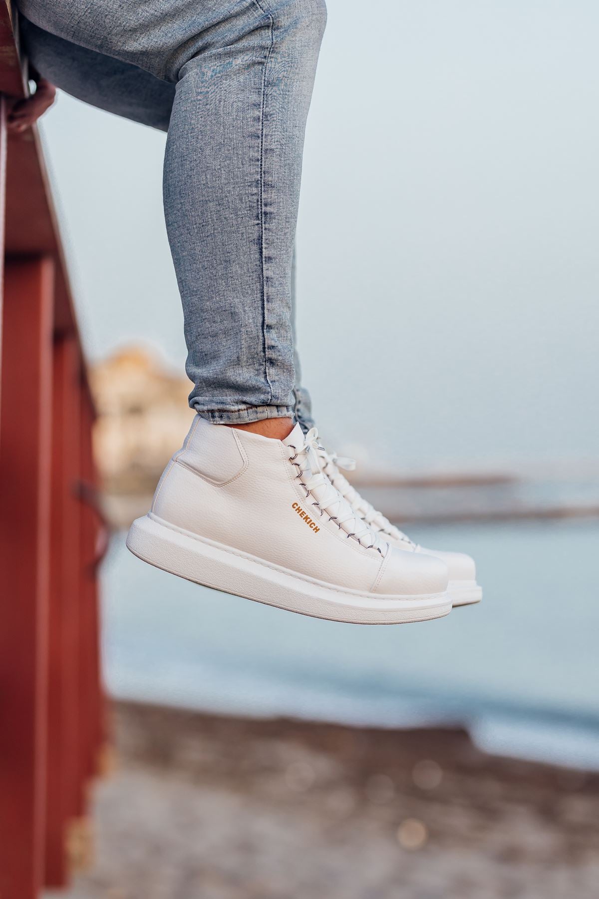 White low-top lace-up boots with side text logo and flat sole