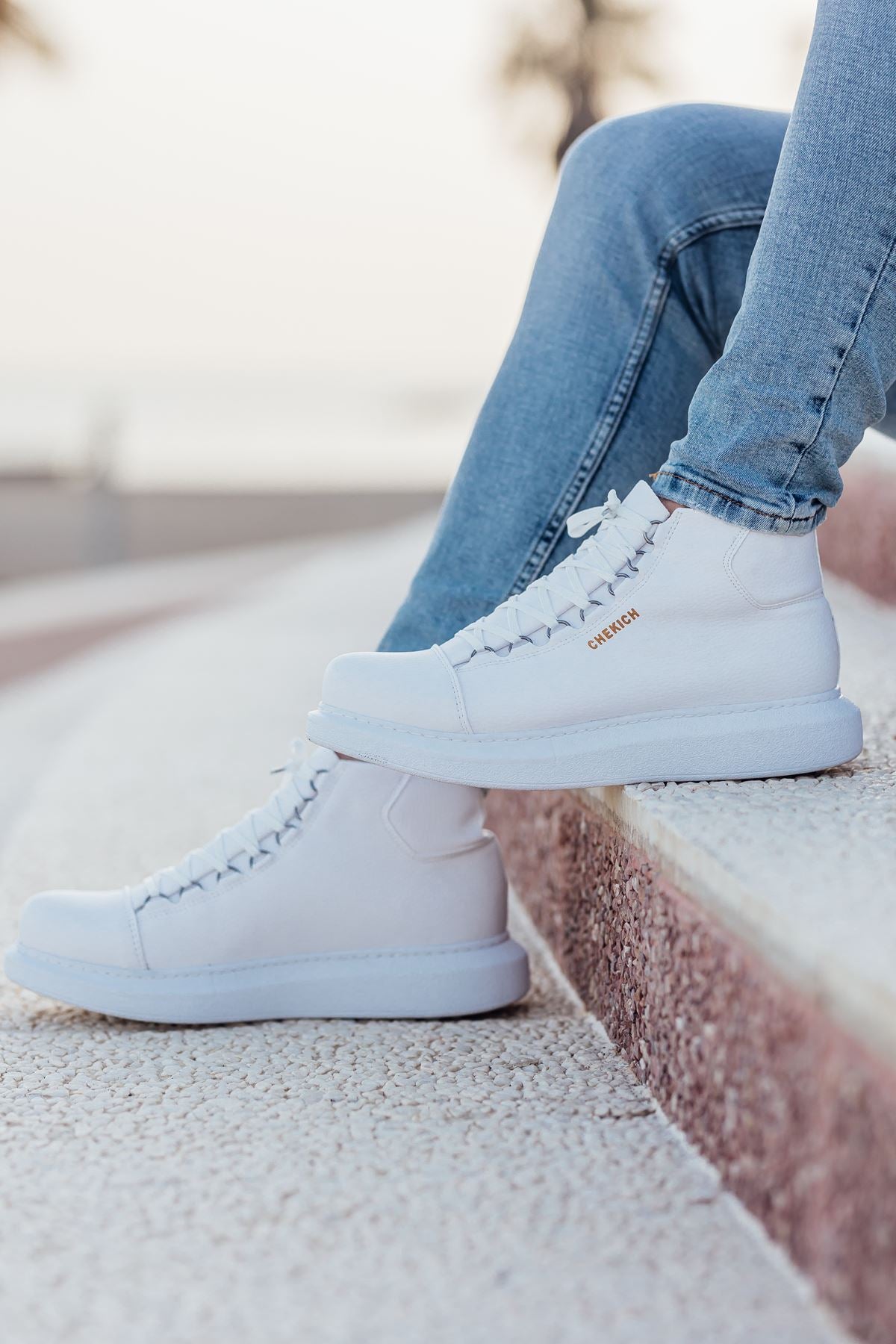 White lace-up boots with visible stitching and textured rubber sole