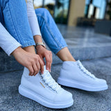 White lace-up boots on a stone step, side view with stitched laces