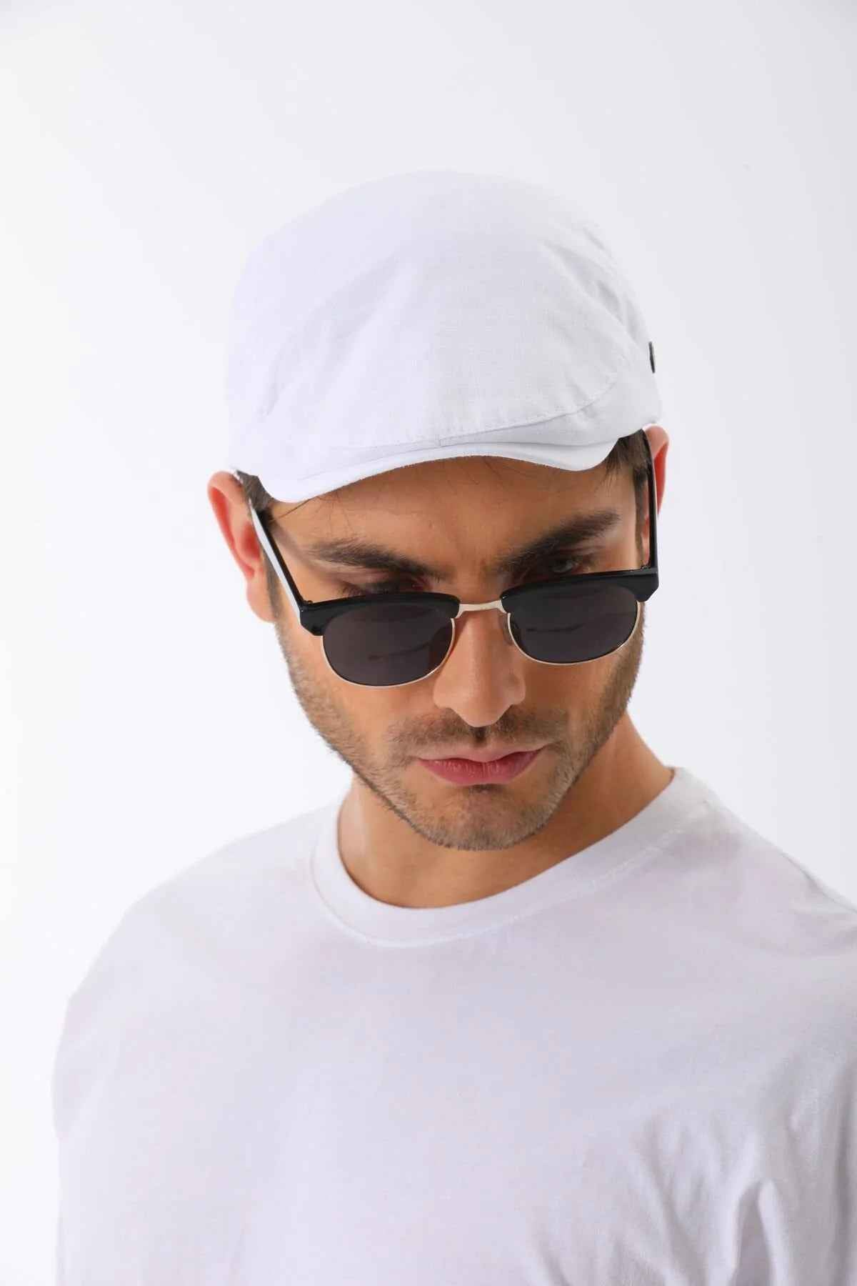 White flat cap with curved brim and small side button