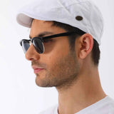 White flat cap side view with small dark button