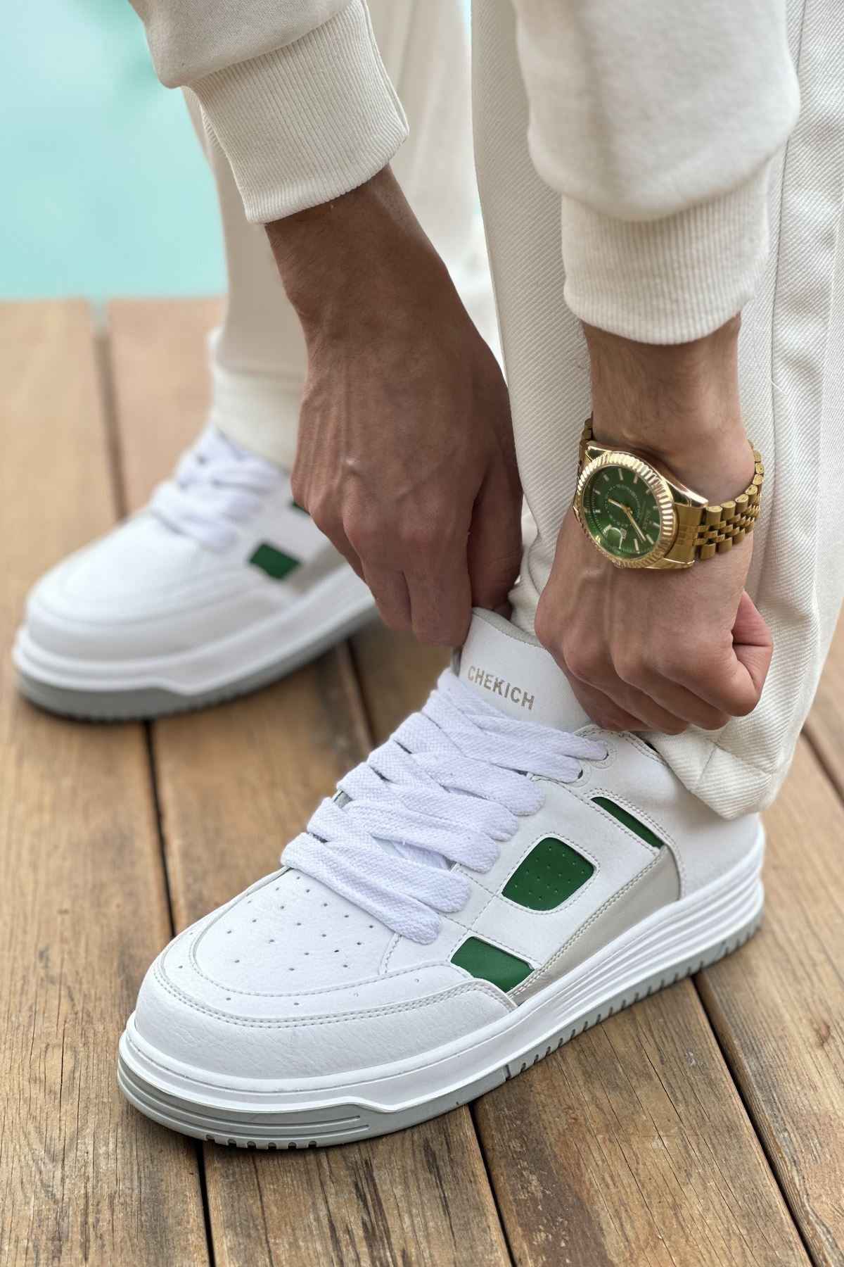 Men's white green low-top sneakers with green side panels and lace-up