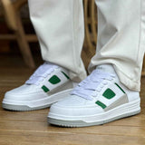 Men's white green low-top sneakers, side view with green accents and white laces