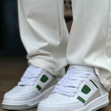 Men's white green low-top sneakers, front view with green side panels and lace-up