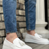 Men's white slip-on loafers with tassel detail and thick rubber sole