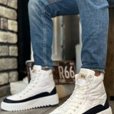White lace-up high boots with navy trim, thick sole, and textured tread