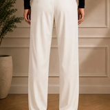 Men's white dress pants with black belt, front crease and straight legs