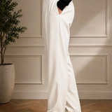 Men's white dress pants side view with black belt and vertical seam