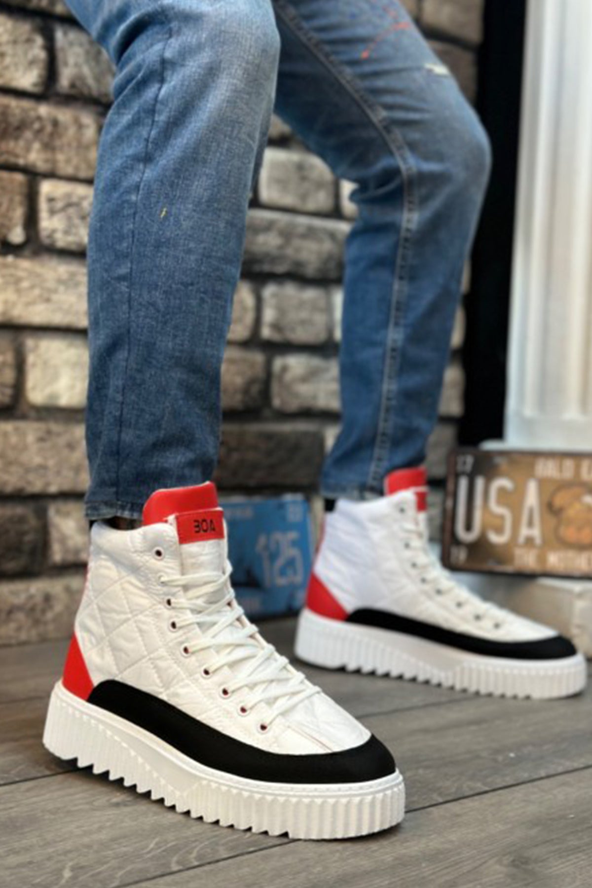 Men's white high-top lace-up boots with red heel, black trim, thick sole