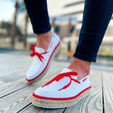 Men's white espadrille shoes with red lace-up detail and jute sole