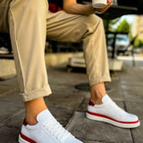 White lace-up sneakers with red side stripe and red heel accent