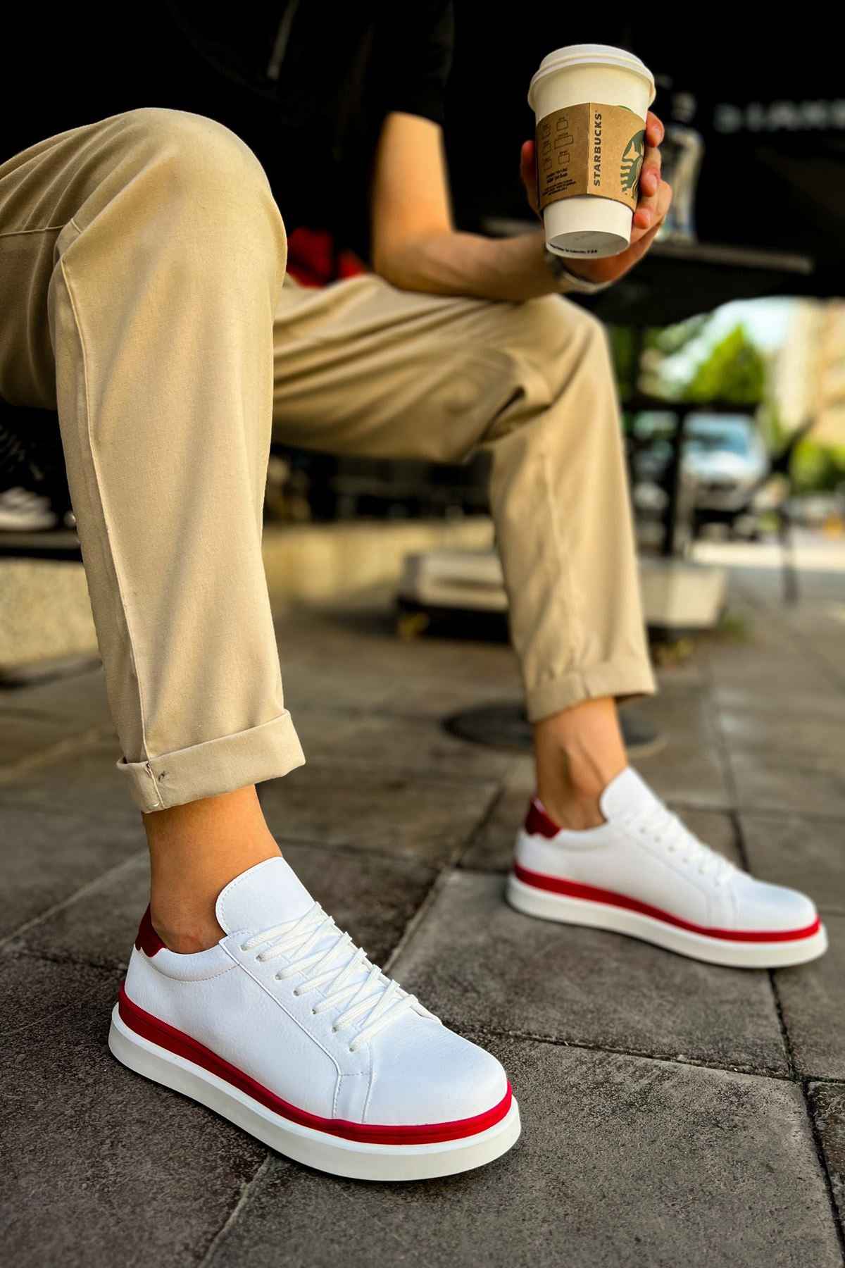 White lace-up sneakers with red side stripe and red heel accent