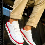 White low-top lace-up sneakers with red piping and red heel trim