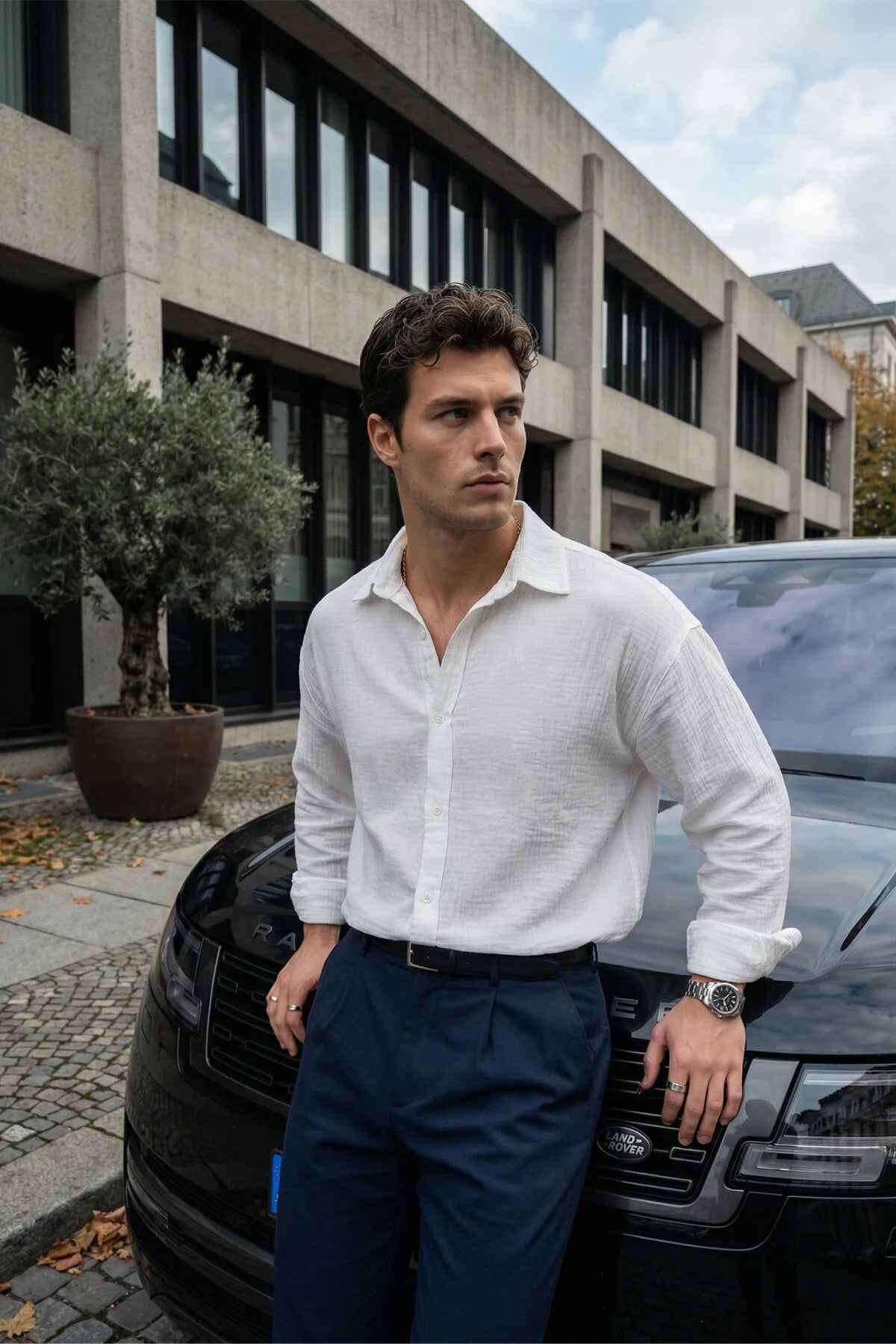 Men's white button-up shirt with pointed collar and long sleeves, front buttons