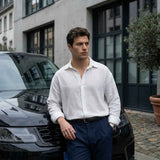 Men's white button-up shirt with long sleeves and open pointed collar, textured fabric