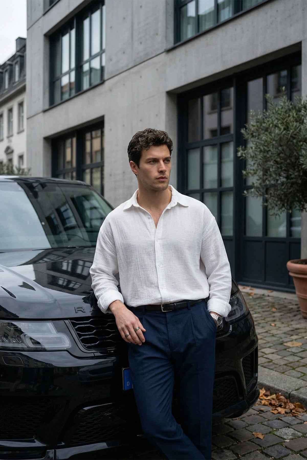 Men's white button-up shirt with long sleeves and open pointed collar, textured fabric