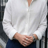 Men's white button-up shirt with pointed collar, visible front placket and cuffs