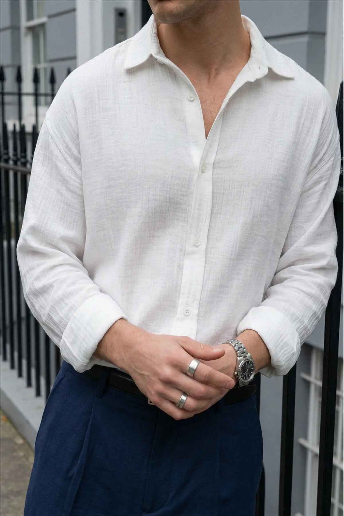 Men's white button-up shirt with pointed collar, visible front placket and cuffs