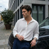 Men's white button-up shirt with long sleeves and pointed collar, button front
