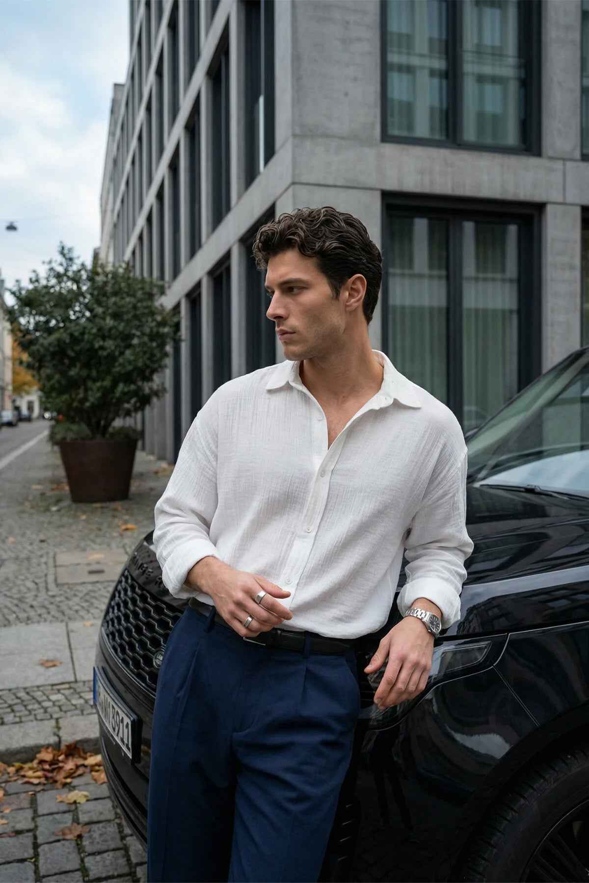 Men's white button-up shirt with long sleeves and pointed collar, button front