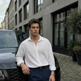 Men's white long-sleeve button-up shirt with pointed collar and chest buttons