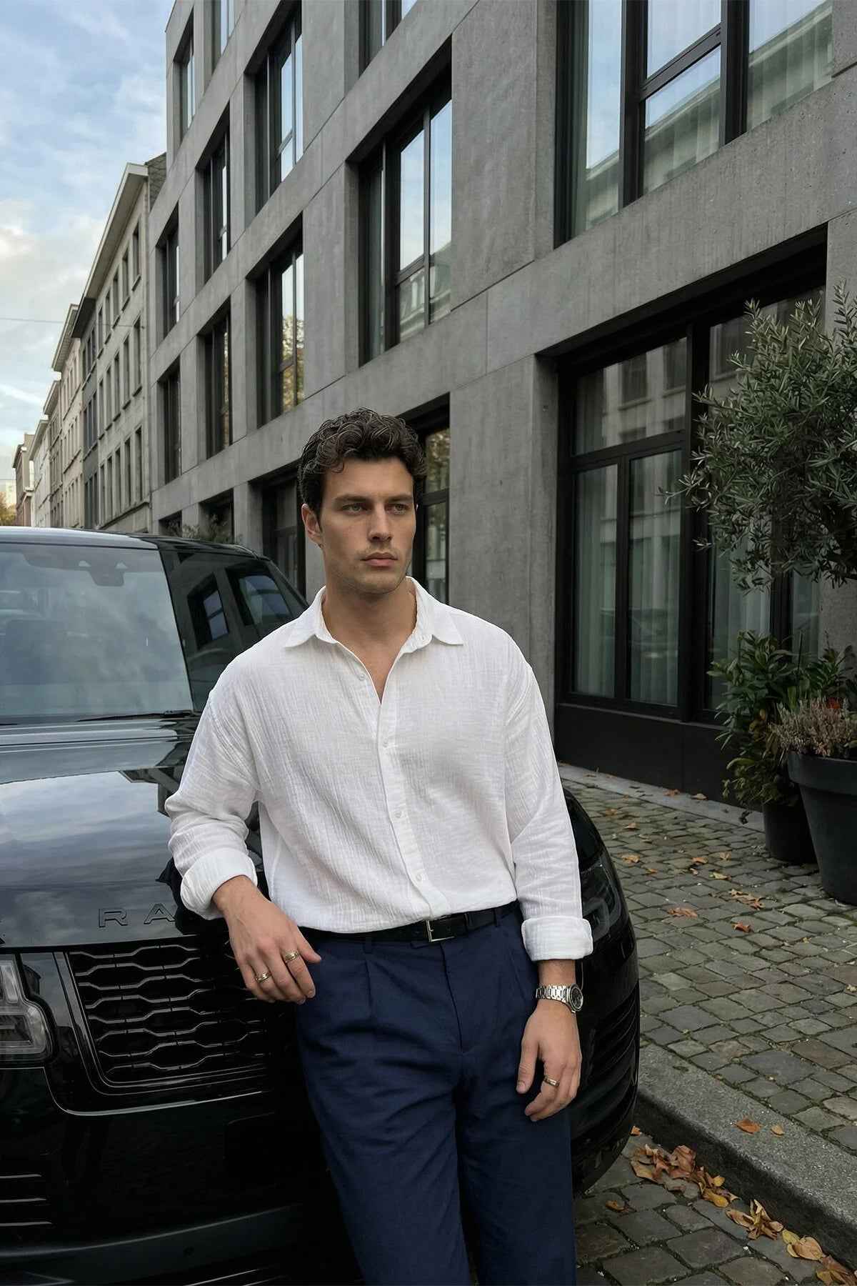 Men's white long-sleeve button-up shirt with pointed collar and chest buttons