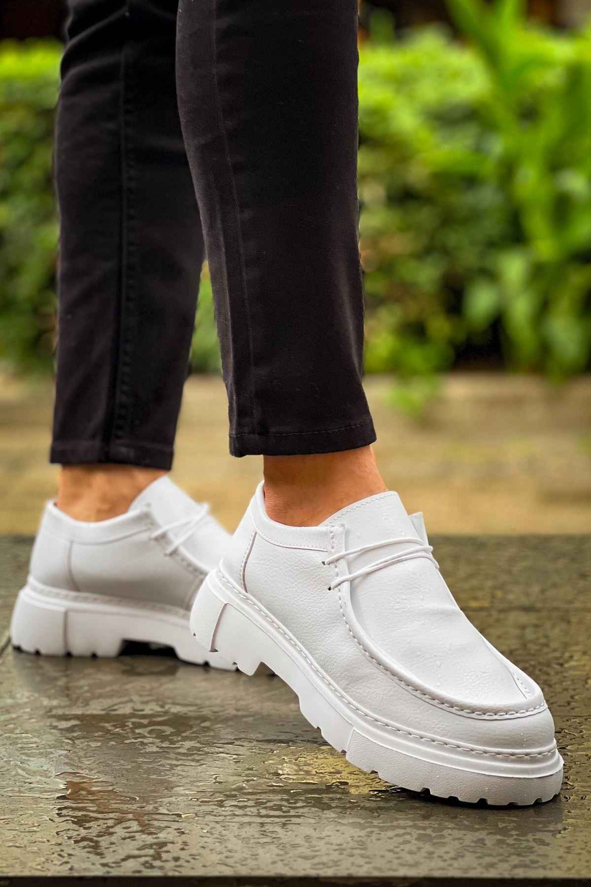 Men's white leather-style lace-up shoes with thick rubber sole, side view
