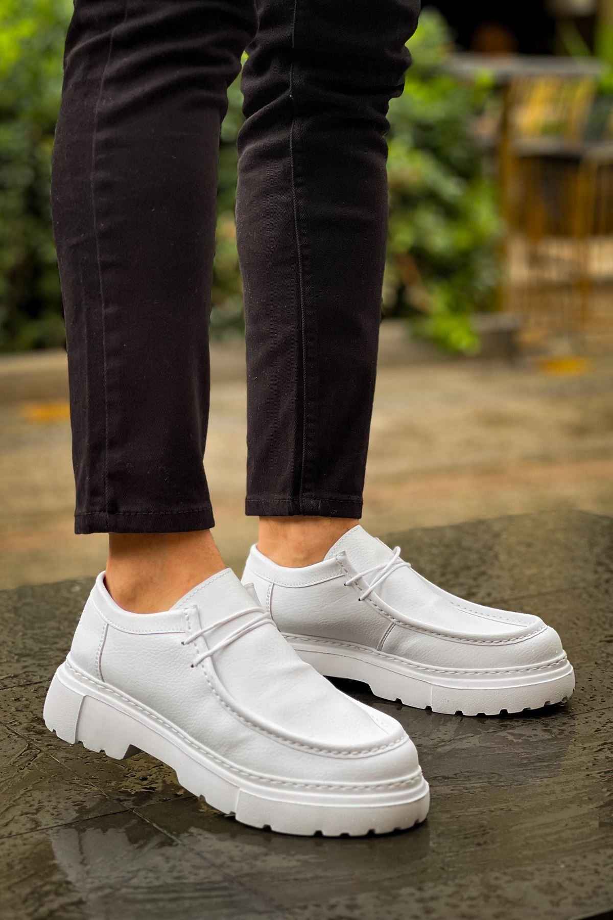 Men's white leather-style lace-up shoes with stitched paneling and thick sole, pair view