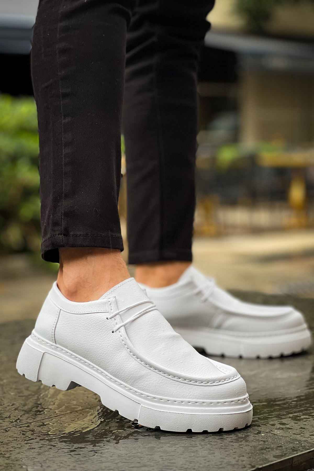 Men's white leather-style lace-up shoes, angled side view with textured sole