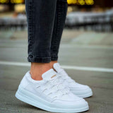 Men's white lace-up sneakers, side view with low-profile rubber sole