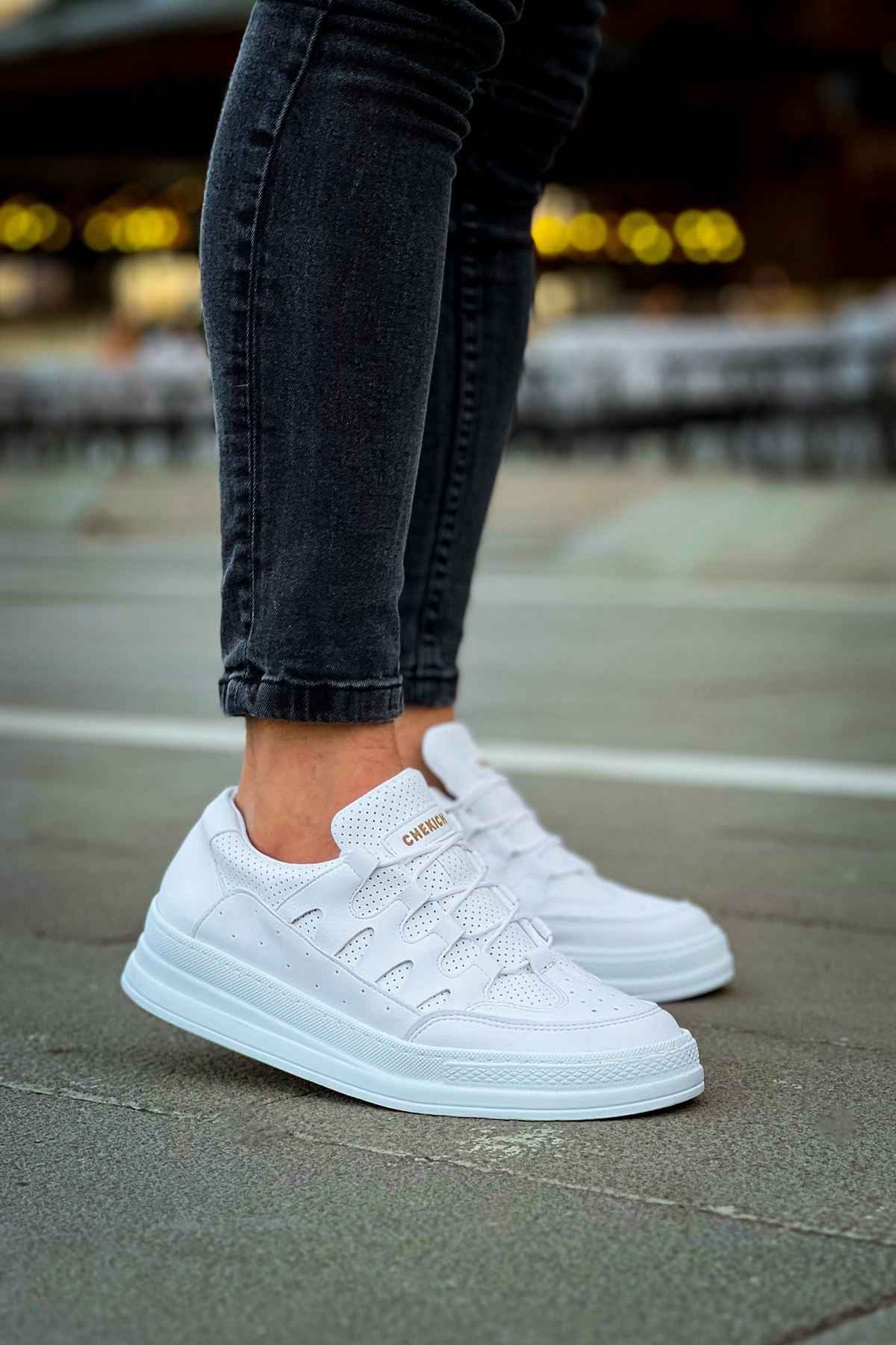 Men's white lace-up sneakers, side view with low-profile rubber sole