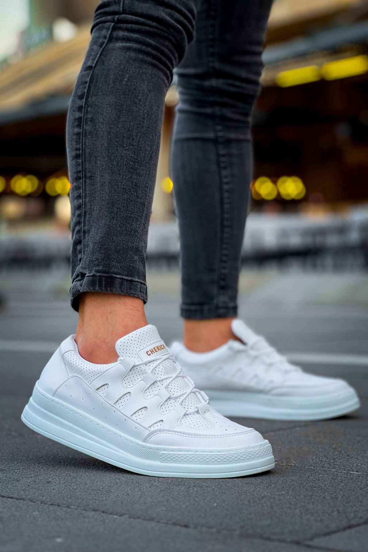 Men's white lace-up sneakers, front-quarter view with perforated panels