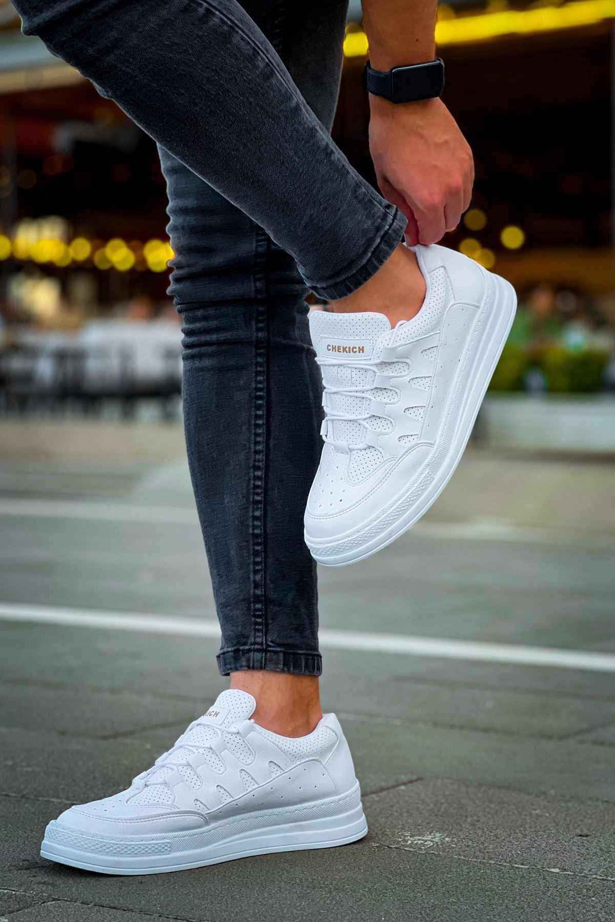 Men's white lace-up sneakers, standing side view with flat rubber sole