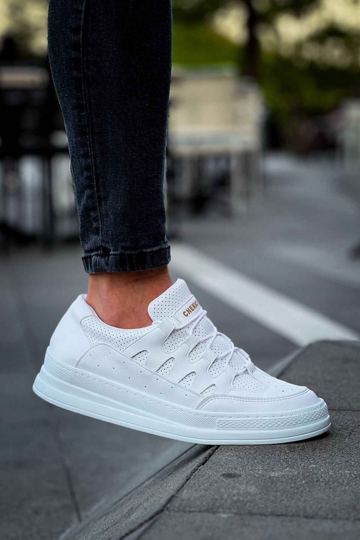 Men's white lace-up sneakers, toe and side view with lace eyelets