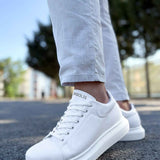 White low-top lace-up sneakers with logo at tongue and rubber sole