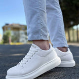 White low-top lace-up sneakers, side view, clean leather upper