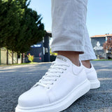 White low-top lace-up sneakers with smooth toe cap and thick sole