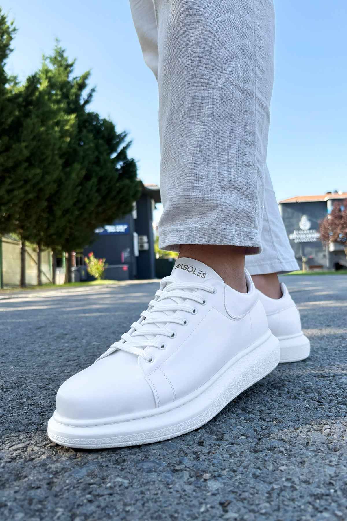 White low-top lace-up sneakers with smooth toe cap and thick sole