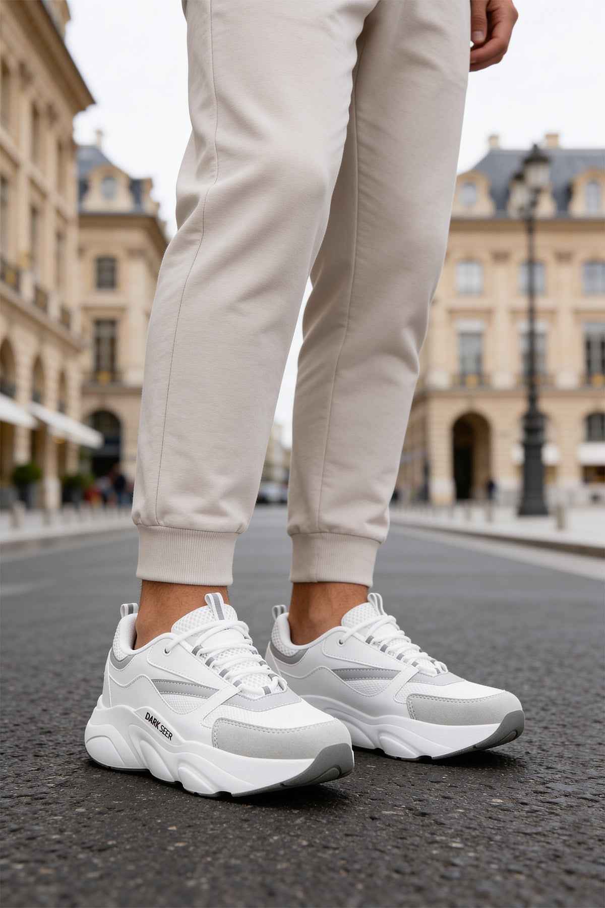 Men's white low-top sneakers, lace-up with chunky sole and side logo.